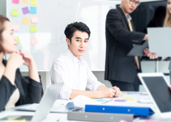 Teamwork business concept .Start up business people in modern office, working together having success. Multiethnic start-up business team on meeting in modern bright office interior brainstorming