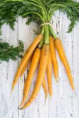 Fresh yellow carrots bunch on a white background with copy space