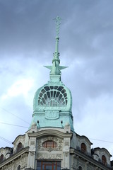 Green spire of AU PONT ROUGE Department Store building in St. Petersburg in summer. Russia