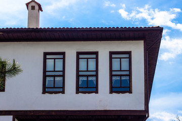 Front shoot of unfinished wooden windows on masonry traditional turkish house in Safranbolu