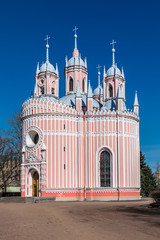 The detached alone red and white Chesme Church in Saint Petersburg, Russia in a sunny day on the background of clear blue sky