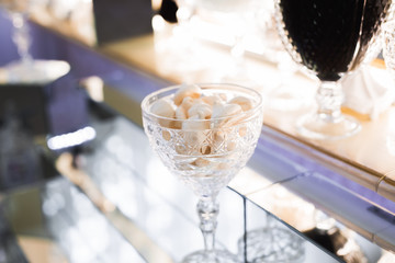 Delicious sweets on wedding candy buffet with desserts, cupcakes