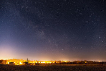 Milky Way over the illuminated small village