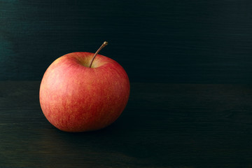 Apple on dark wooden background