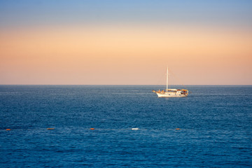 Peaceful sea landscape with a boat in the evening colours