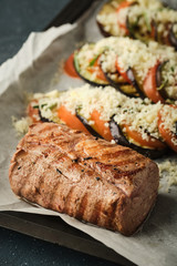 Veal tenderloin with vegetables, eggplants and tomatoes.