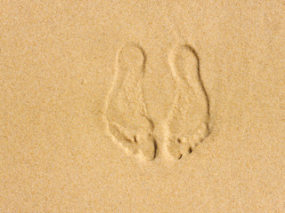 Footprints in the sand at the sea