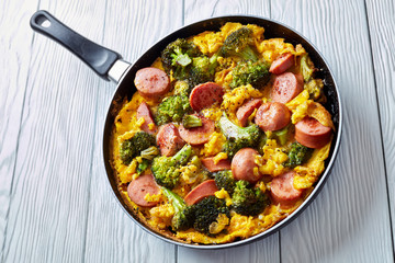 hot Omelette with broccoli and sausages, close-up