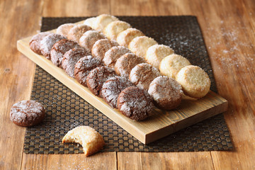 Three Chocolate Diamond Cookies, on wooden background.