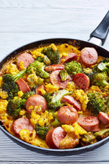 breakfast; egg; sausage; scrambled; skillet; broccoli; frittata; omlette; omelet; white; hearty; american; comfort; cooked; gourmet; food; eat; bratwurst; overhead; above; close-up; closeup; cuisine; 
