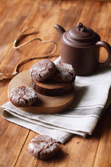 Three Chocolate Diamond Cookies, on wooden background.
