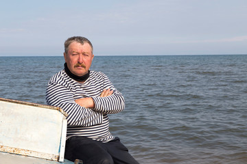 The captain sits on a boat