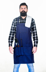 Outdoor cooking. Bearded man wearing apron with grill gripper tools in pockets. Hipster with metal utensils for barbecue grill. Grill cook. Preparing food on grill using a barbecue set