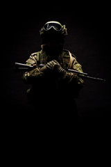 russian special forces soldier with rifle on dark background. army, military and people concept