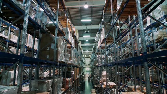 A variety of goods and cargo on the shelves in a large warehouse