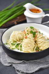 pasta with pesto sauce and basil