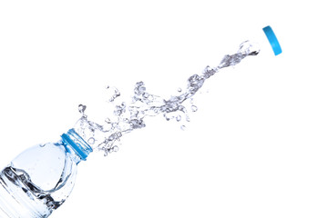 Water splash out of bottle isolated on white background.
