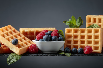 Belgian waffles with  blueberries, raspberries  and fresh mint.