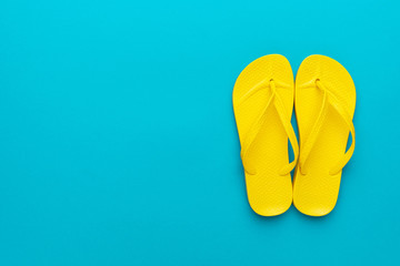yellow beach flip-flops on the blue background