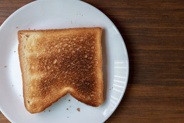 overdoned bread  on white plate