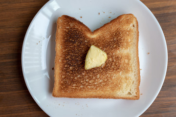 overdoned bread  on white plate