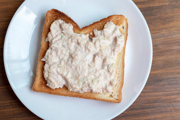 close up of tuna sandwich on white plate