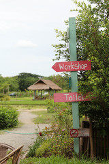 Pink wooden sign in the garden.
