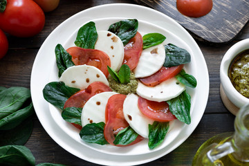 Caprese salad with pesto and balsamic vinegar 