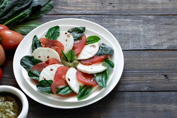 Caprese salad with pesto and balsamic vinegar 