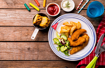 Kid's meal - chicken strips, fries, salad, corn and dips