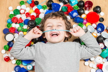 Child lying on the floor surrounded by plastic stoppers.