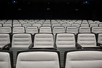 Empty grey seats in theatre or conference