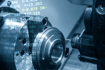 The abstract scene of CNC lathe machine and G-code data. CNC lathe machine cutting slot with milling turret.