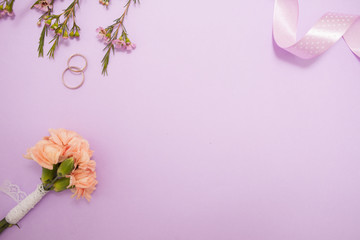 Cute minimalistic flat lay on the wedding theme in delicate lavender colors.