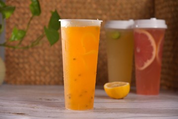 glass of orange juice on wooden table