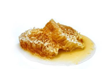 Natural wild honeycomb slice isolated on white background