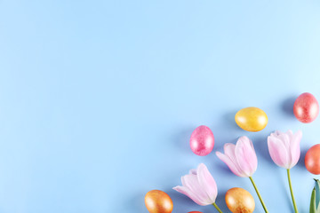 Bunch of hand painted Easter eggs of different pastel glossy color on bright paper background with a lot of copy space for text. Top view, flat lay, close up. Easter greeting card concept.