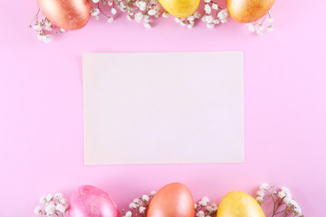 Festive flower composition with white gypsophila flowers on pink background. Blank Easter greeting card with painted eggs for Christian religious holiday. Close up, copy space, flat lay, top view.