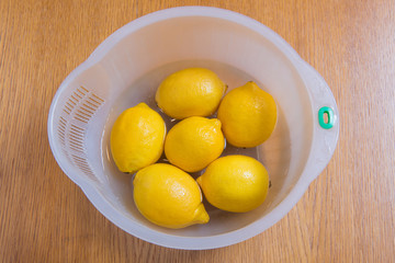 Fresh yellow lemons on a wooden background.