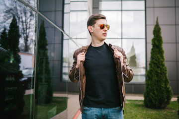 A stylish man in a black T-shirt. Street photo