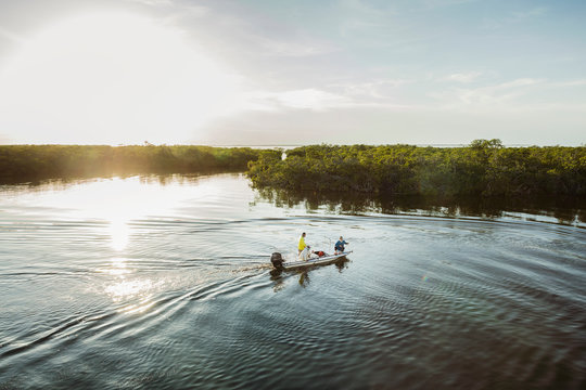 Fisherman in boat in cove of a caribbean island in cuba