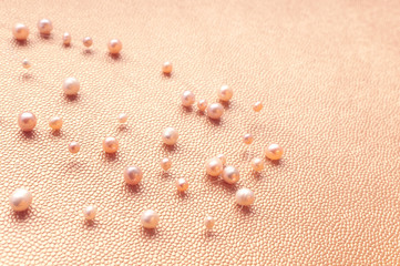 Pearl necklace on a gold background. close-up. Space for text.
