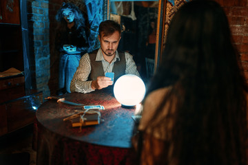 Young people at the table with crystal ball