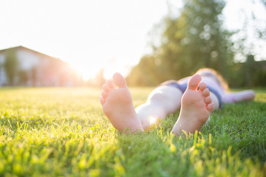 man lying on the lawn. feet close-up. outdoor rest on a summer day.