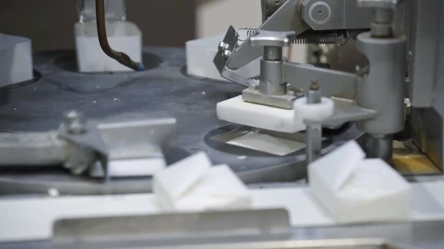Conveyor with cottage cheese packaging in diary factory. Cheese production line. Cheese manufacturing line