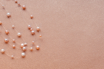 Pearl necklace on a gold background. Flat lay, top view. Minimal style. Space for text.