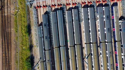 Aerial view over passenger trains in rows at a station