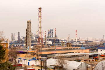 The territory of the power plant. Factory buildings with pipes