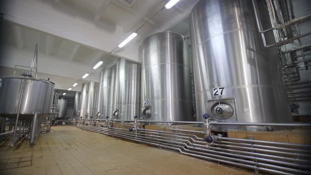 Special modern equipment for pasteurize milk. Huge cisterns for storing and fermenting milk. Equipment at dairy plant.