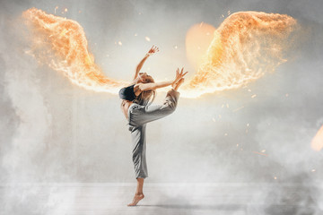 fit woman has fire wings while dancing